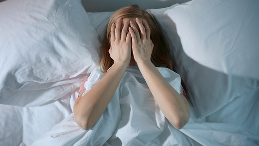 frustrated girl with hands over her face struggling with insomia 
